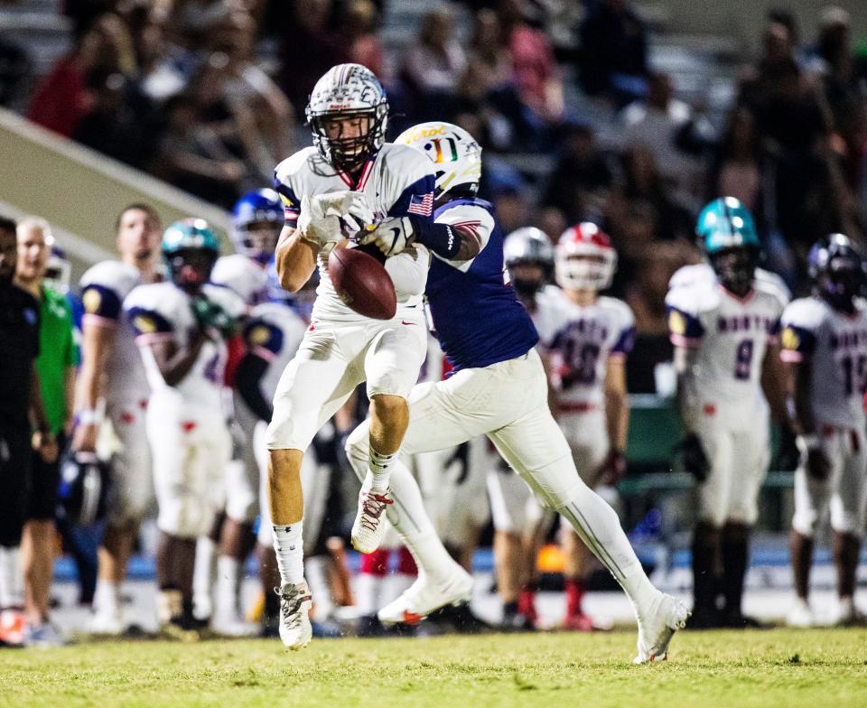 North's Tucker Devaney has  a play broken up by  a South player as he tries to make a catch during 33rd annual Rotary South All-Star Game at Fort Myers High on Wednesday, Dec. 8, 2021.