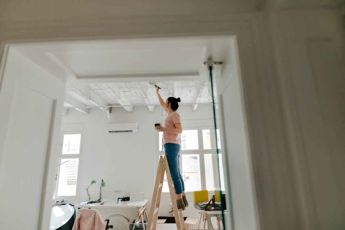 Woman painting ceiling