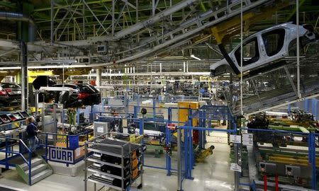 An employee of German car manufacturer Mercedes Benz observes the connection between the bodywork and the chassis of an A class (A-Klasse) model at their production line at the factory in Rastatt, Germany, January 22, 2016. REUTERS/Kai Pfaffenbach