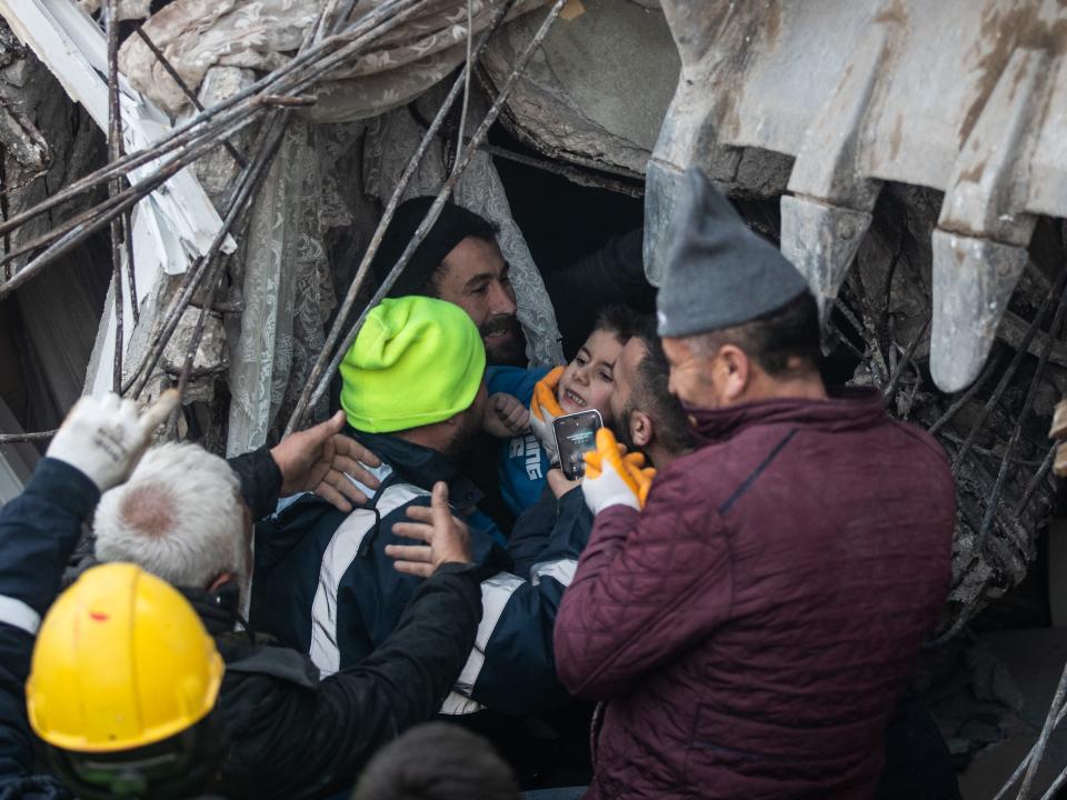 Rescue workers carry Yigit Cakmak, 8-years-old survivor at the site of a collapsed building 52 hours after the earthquake struck, on February 08, 2023 in Hatay, Turkey. A 7.8-magnitude earthquake hit near Gaziantep, Turkey, in the early hours of Monday, followed by another 7.5-magnitude tremor just after midday