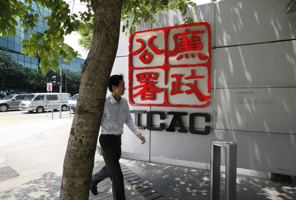 A man walks past the logo of the Independent Commission Against Corruption (ICAC), the Hong Kong anti-corruption police office in Hong Kong Friday, May 4, 2012. The former chief executive of Hong Kong developer Sun Hung Kai Properties Ltd. was arrested by ICAC officials Thursday night in a high profile anti-corruption probe that has already targeted his billionaire brothers and a top official. (AP Photo/Kin Cheung)