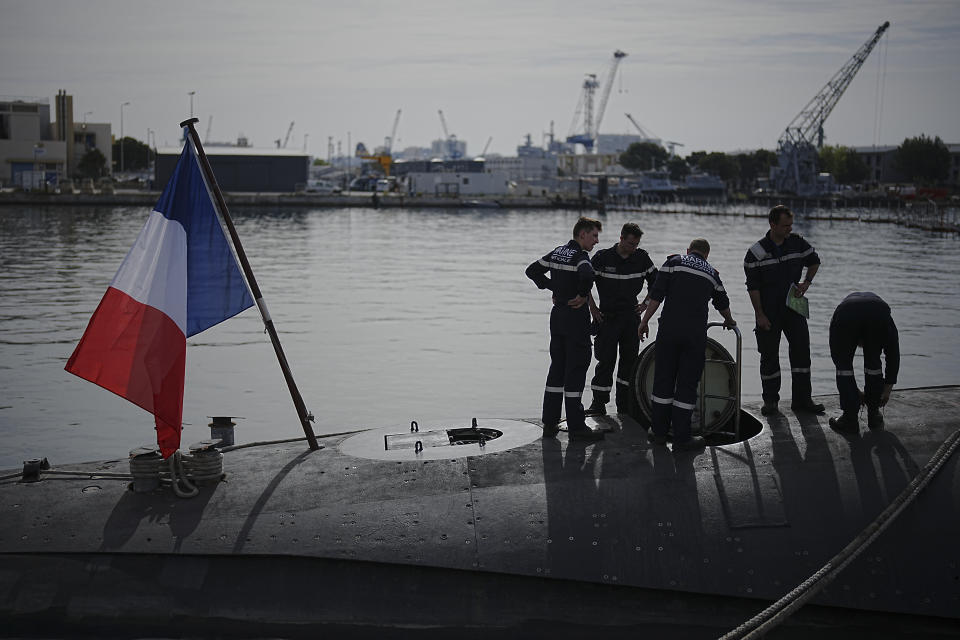 Sailors prepare a French Rubis-class submarine at the Toulon naval base in southern France, Monday, April 15, 2024. The nuclear powered submarine will be guarding France's Charles de Gaulle aircraft carrier during training exercises dubbed Neptune Strike in the Mediterranean with the 32-nation NATO military alliance. (AP Photo/Daniel Cole)