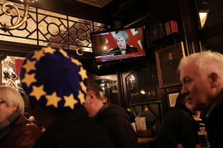 Customers in the Red Lion pub watch television sets broadcasting a news conference by Britain's Prime Minister, Theresa May, in London, Britain November 15, 2018. REUTERS/Simon Dawson/Files