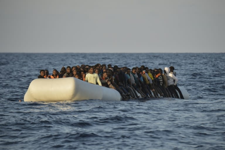 Migrants drift on a rubber boat shortly before being rescued off the Libyan coast in the Mediterranean Sea, in November 2016