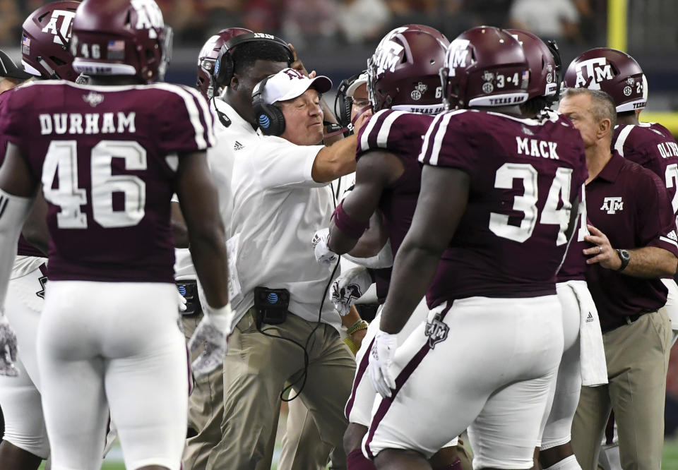 Texas A&M head coach Jimbo Fisher tries to calm his players after tempers flared during Saturday’s game against Arkansas. (AP)