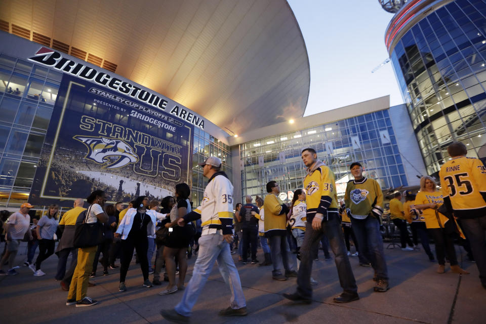 FILE - In this April 10, 2019, file photo, fans arrive at Bridgestone Arena for Game 1 of an NHL hockey first-round playoff series between the Nashville Predators and the Dallas Stars in Nashville, Tenn. It's unclear when or if the coronvirus pandemic-delayed NHL playoffs -- which were supposed to begin Wednesday -- will be played or what form they'll resemble. (AP Photo/Mark Humphrey, FIle)