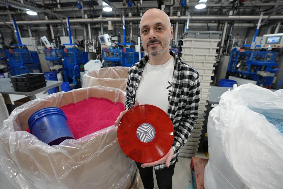 Paul Miller, VP of sales at Precision Record Pressing in Burlington, Ont., shows off an album pressed from the company's recycled Eco Mix vinyl on Dec. 19, 2023.