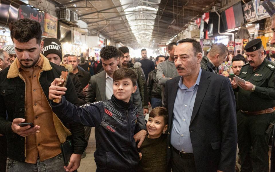 Al-Jabouri poses for selfies at the Nabi Yunus market - Sam Tarling 