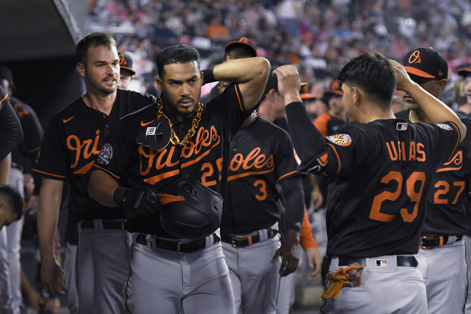 Baltimore Orioles' Anthony Santander, left foreground, is congratulated by Ramon Urias (29) after Santander hit a home run off Detroit Tigers relief pitcher Jacob Barnes during the eighth inning of a baseball game Friday, May 13, 2022, in Detroit. (AP Photo/Jose Juarez)
