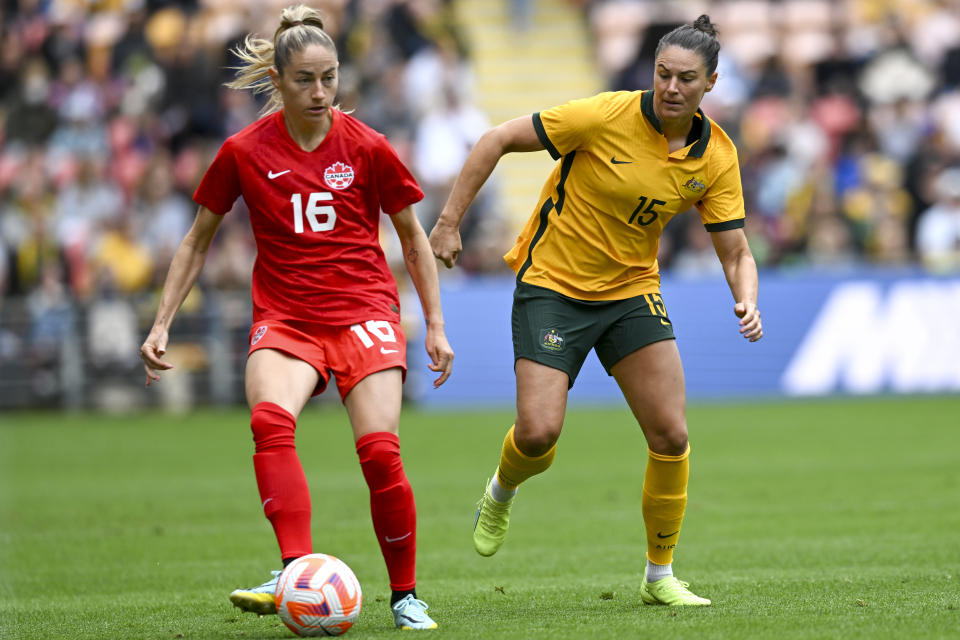 Janine Beckie, left, of Canada battles fort the ball with Emily Gielnik of Australia during the women's soccer friendly between Australia and Canada at Suncorp Stadium in Brisbane, Australia, Saturday, Sept. 3, 2022. (Darren England/AAP Image via AP)