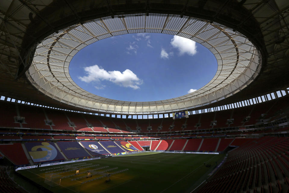 Employees prepare the National Stadium for the tomorrow's Copa America soccer tournament in Brasilia, Brazil, Saturday, June 12, 2021. The stadium will host Sunday's opening match between Brazil and Venezuela. (AP Photo/Eraldo Peres)