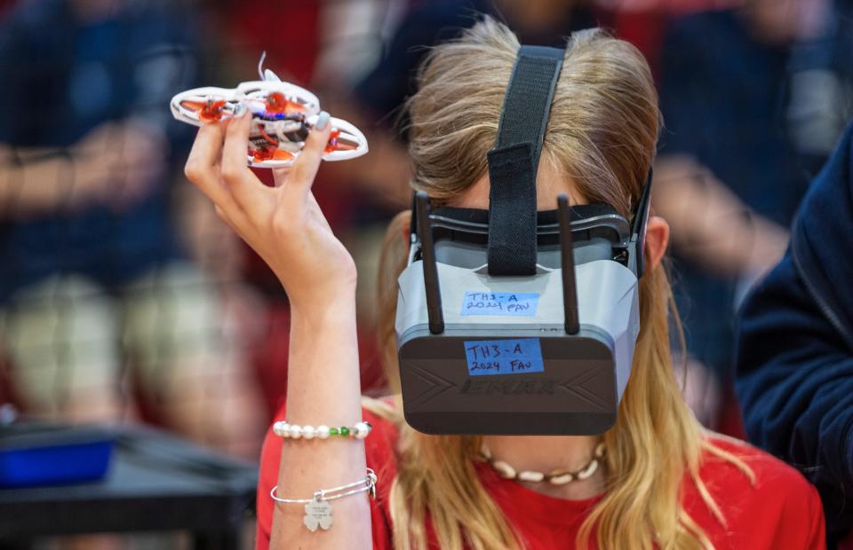Amelia Nance tests her goggles before racing her opponent during a drone competition at the A.D. Henderson & FAU High School Gymnasium on January 19, 2024 in Boca Raton, Florida. The competition was sponsored by Florida Power & Light Company and its education partner, Drones in School, an after-school program that encourages students to pursue STEM careers.