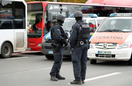 Police officers stand guard near the site of a shooting in Halle