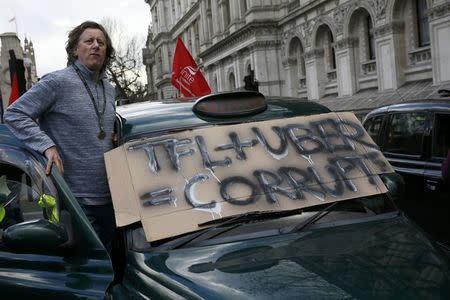A London cab driver takes part in a protest by London cab drivers against Uber in central London, Britain February 10, 2016. REUTERS/Stefan Wermuth