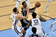 Sacramento Kings guard Delon Wright (55) looks to shoot against Memphis Grizzlies forwards Jaren Jackson Jr. (13) and Kyle Anderson (1) in the second half of an NBA basketball game Thursday, May 13, 2021, in Memphis, Tenn. (AP Photo/Brandon Dill)