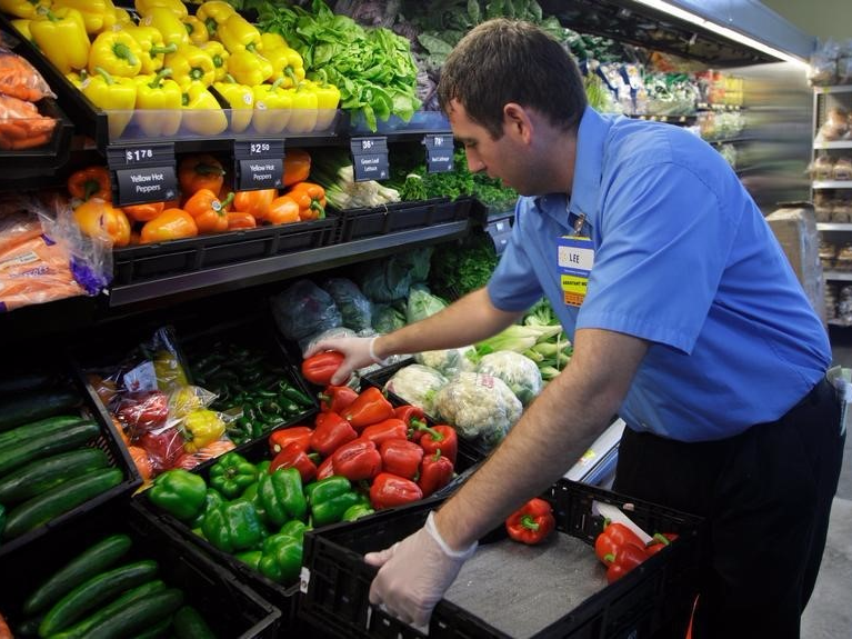 A worker stocks a new Walmart Express store in Chicago July 26, 2011. 
REUTERS/John Gress  