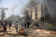 Protestors take to the streets of Burkina Faso's capital Ouagadougou Saturday Nov. 27, 2021, calling for President Roch Marc Christian Kabore to resign. The protest comes after the deadliest attack in years against the security forces in the Sahel's Soum province earlier this month, where more than 50 security forces were killed and after an attack in the Center North region where 19 people including nine members of the security forces were killed. (AP Photo/Sophie Garcia)