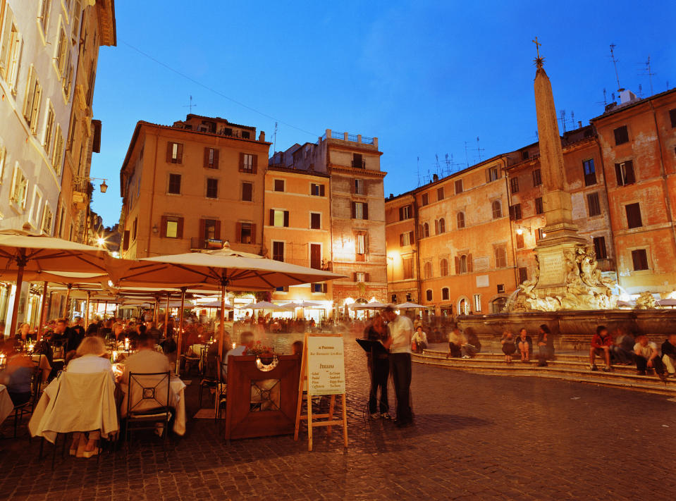A busy restaurant in an Italian plaza.