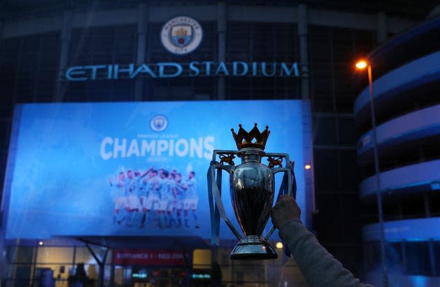 Manchester City fans celebrate the club's Premier League triumph at the Etihad Stadium