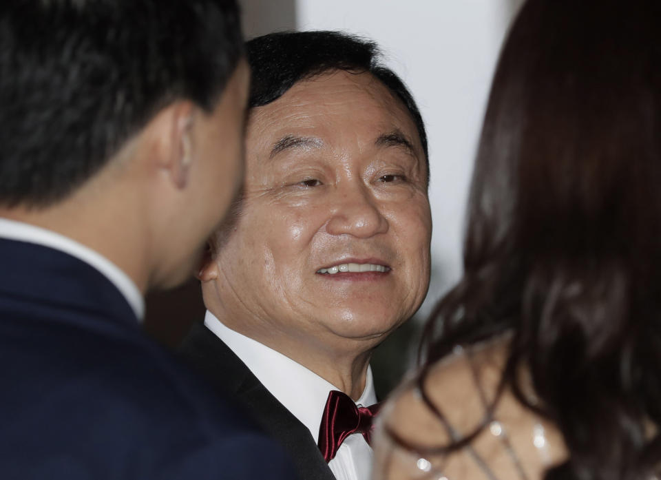 Former Thai Prime Minister Thaksin Shinawatra, center, chats with guests for his daughter's wedding at a hotel in Hong Kong, Friday, March 22, 2019. (AP Photo/Kin Cheung)