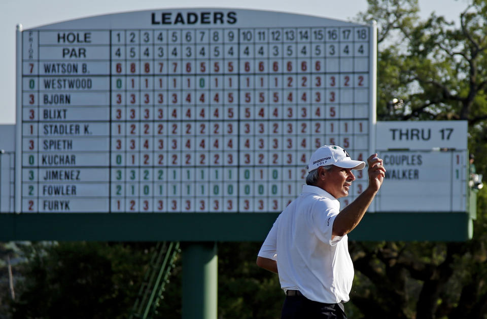 Fred Couples holds up his ball on the 18th green after his third round of the Masters golf tournament Saturday, April 12, 2014, in Augusta, Ga. (AP Photo/Matt Slocum)