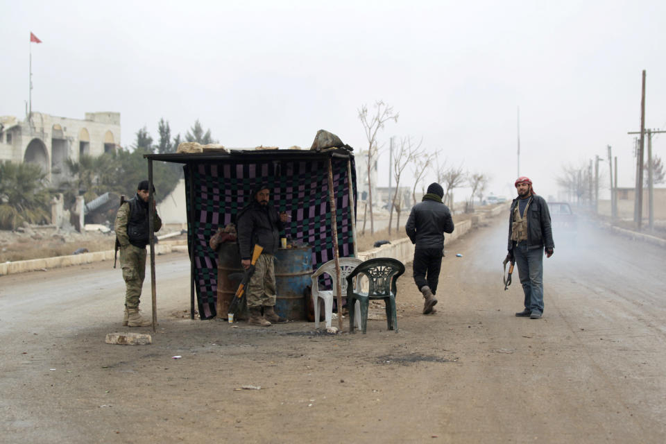 Rebel fighters man a checkpoint on an entrance to al-Rai town, northern Aleppo countryside, Syria December 25, 2016. REUTERS/Khalil Ashawi