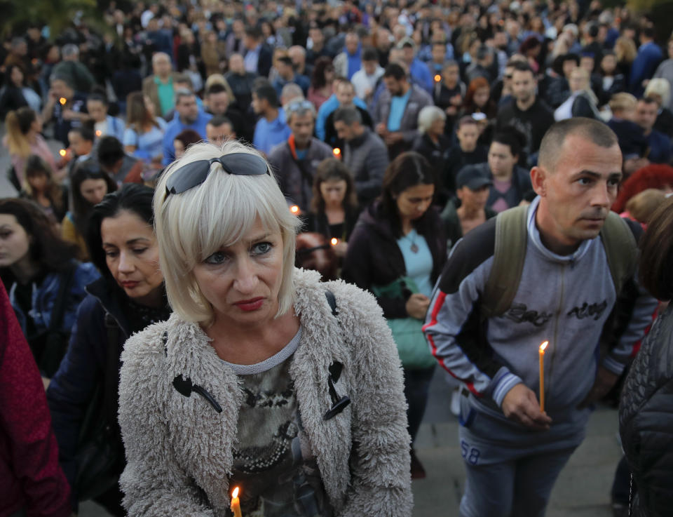 People wait during a vigil for slain television reporter Viktoria Marinova in Ruse, Bulgaria, Monday, Oct. 8, 2018. Bulgarian police are investigating the rape, beating and slaying of a female television reporter whose body was dumped near the Danube River after she reported on the possible misuse of European Union funds in Bulgaria (AP Photo/Vadim Ghirda)