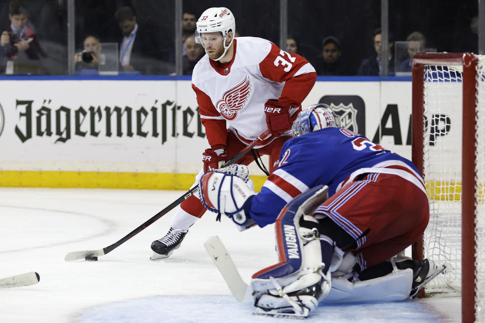 Detroit Red Wings left wing J.T. Compher (37) looks to shoot past New York Rangers goaltender Jonathan Quick in the first period of an NHL hockey game Tuesday, Nov. 7, 2023, in New York. (AP Photo/Adam Hunger)