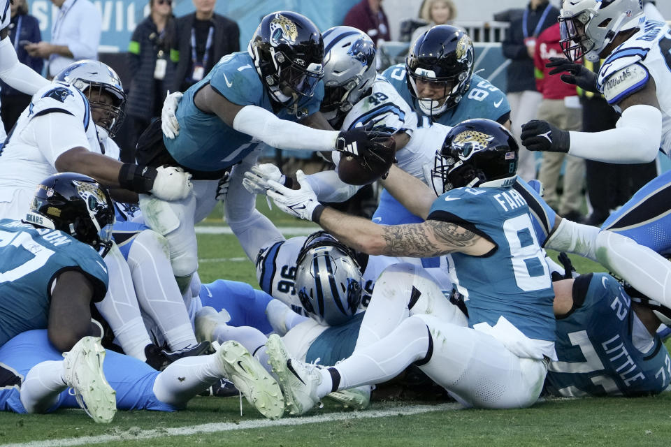 Jacksonville Jaguars running back Travis Etienne Jr. scores against the Carolina Panthers during the second half of an NFL football game Sunday, Dec. 31, 2023, in Jacksonville, Fla. (AP Photo/John Raoux)