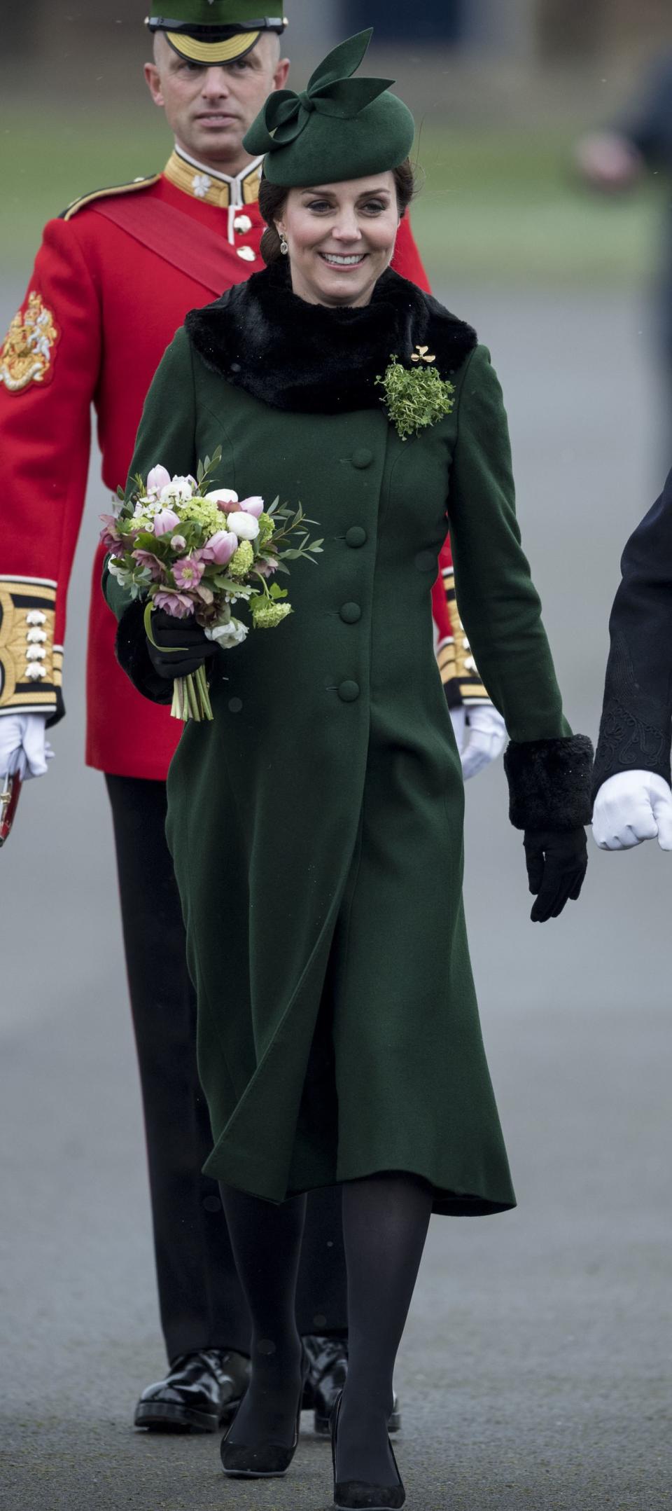 Kate Middleton, in a green Catherine Walker coat, and Prince William celebrated St. Patrick's Day in west London with the 1st Battalion of the Guards regiment.