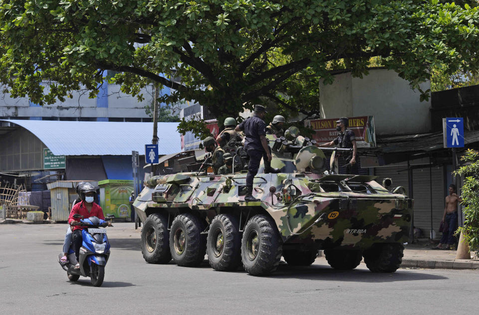 Sri Lankan army soldiers patrol during curfew in Colombo, Sri Lanka, Wednesday, May 11, 2022. Sri Lanka's defense ministry ordered security forces on Tuesday to shoot anyone causing injury to people or property to contain widespread arson and mob violence targeting government supporters. (AP Photo/Eranga Jayawardena)