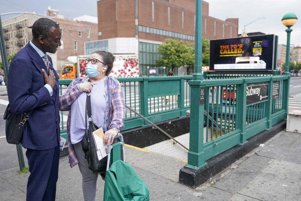 New York City Council candidate Yusef Salaam, left, talks to a Harlem resident while canvasing in the neighborhood, Wednesday, May 24, 2023, in New York. Salaam is one of three candidates in a competitive June 27 Democratic primary. With early voting already begun, he faces two seasoned political veterans: New York Assembly members Al Taylor, 65, and Inez Dickens, 73, who previously represented Harlem on the City Council. (AP Photo/Mary Altaffer)