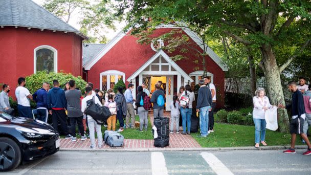 PHOTO: Migrants stand outside St. Andrew's Church in Edgartown, Massachusetts, Sept. 14, 2022. (Ray Ewing/Vineyard Gazette via Reuters)