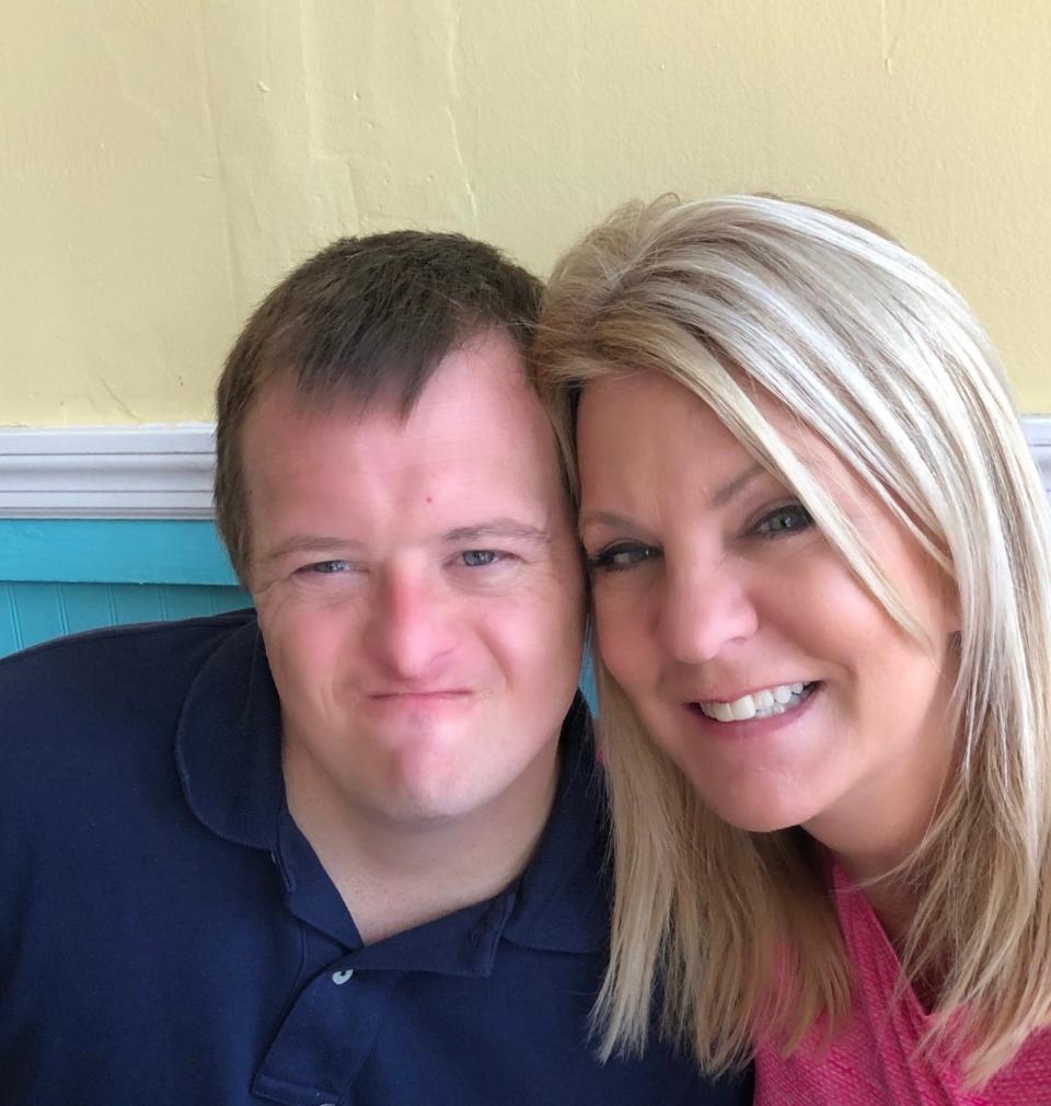 Nick Revels, who has Down syndrome, poses for a picture with his mother, Debbie Revels, executive director of the Down Syndrome Association of Jacksonville. The group was among four Florida organizations that waged the #AShotAtTheShot campaign in early 2021 to lobby state health officials to grant COVID-19 vaccination priority to adults with Down syndrome.