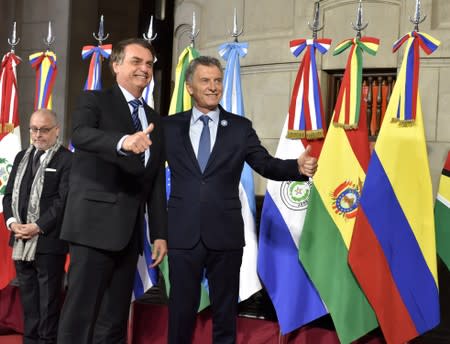 Argentina's President Mauricio Macri and his Brazilian counterpart Jair Bolsonaro pose at the 54th Summit of Heads of State of Mercosur and Associated States, in Santa Fe