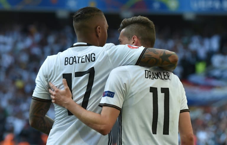 Germany's midfielder Julian Draxler (R) celebrates with Germany's defender Jerome Boateng after scoring against Slovakia in Villeneuve-d'Ascq, near Lille, on June 26, 2016