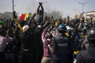 Demonstrators shout slogans in front of riot policemen during a protest against the arrest of opposition leader and former presidential candidate Ousmane Sonko, Senegal, Monday, March 8, 2021. Senegalese authorities have freed opposition leader Ousmane Sonko while he awaits trial on charges of rape and making death threats. The case already has sparked deadly protests threatening to erode Senegal's reputation as one of West Africa’s most stable democracies. (AP Photo/Leo Correa)