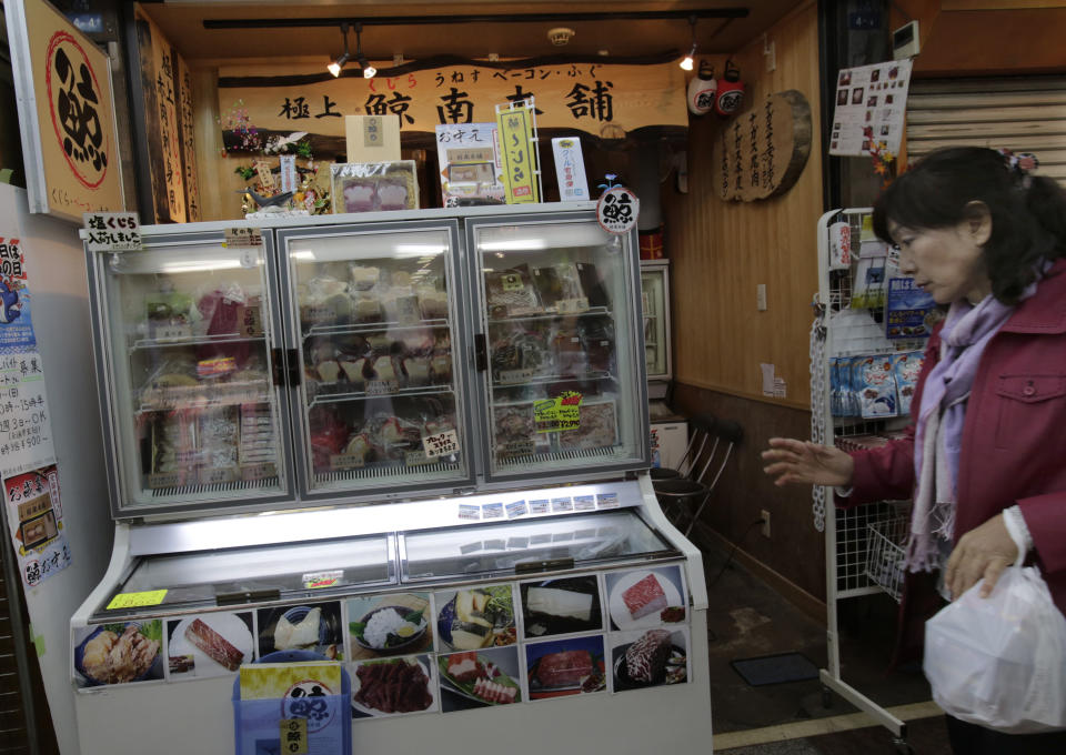 A shopper walks past a whale meat specialty store at Tokyo's Ameyoko shopping district, Thursday, March 27, 2014. The greatest threat to Japan’s whaling industry may not be the environmentalists harassing its ships or the countries demanding its abolishment, but Japanese consumers. They’ve simply lost their appetite. The amount of whale meat stockpiled for lack of buyers has nearly doubled over 10 years, even as anti-whaling protests helped drive catches to record lows. More than 2,300 mink whales worth of meat is sitting in freezers while whalers still plan to catch another 1,300 whales per year. Uncertainty looms ahead of an International Court of Justice ruling expected Monday over a 2010 suit filed by Australia, which argues that Japan’s whaling - ostensibly for research - is a cover for commercial hunts. (AP Photo/Shizuo Kambayashi)