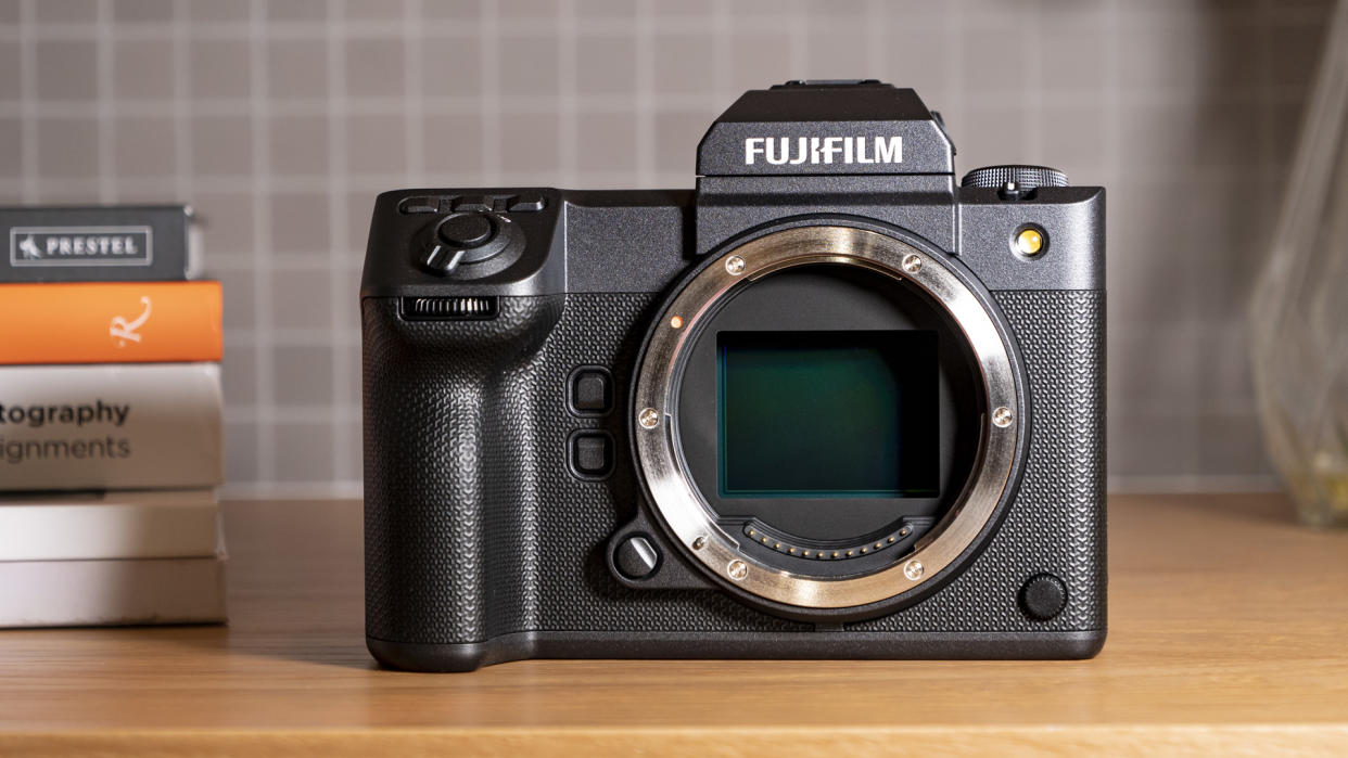  Fujifilm GFX100 II camera on a wooden table with medium format sensor visible 