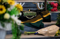 A Humboldt Broncos team jersey is seen among notes and flowers at a memorial for the Humboldt Broncos team leading into the Elgar Petersen Arena in Humboldt, Saskatchewan, Canada April 7, 2018. REUTERS/Matt Smith