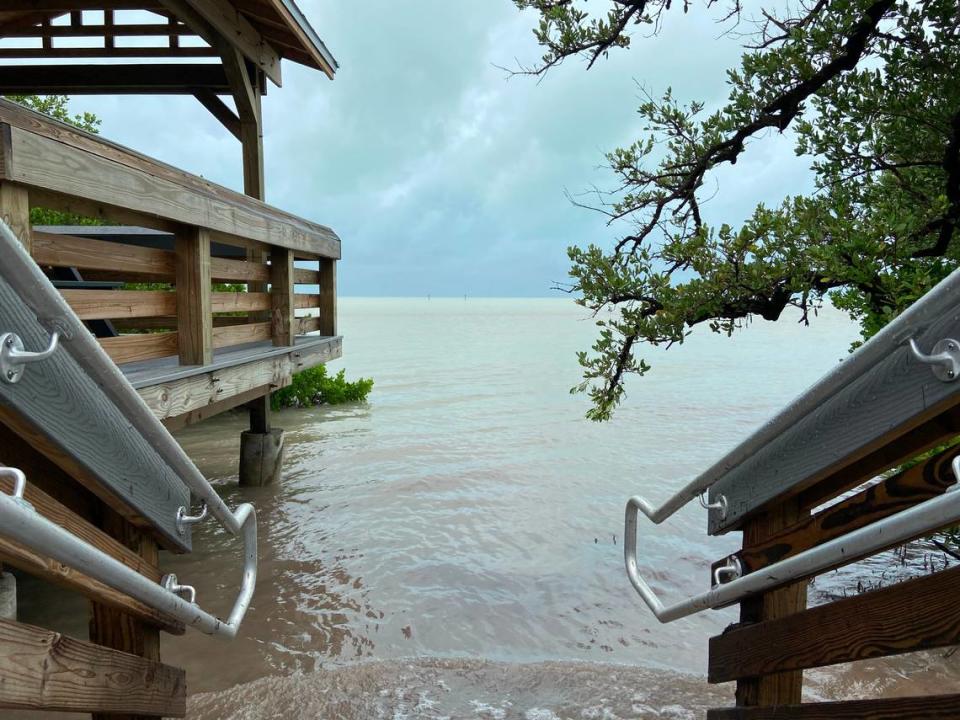 Water from the ocean flows over the sand to the steps of the boardwalk at Anne’s Beach in Islamorada Sunday, Nov. 8, 2020.