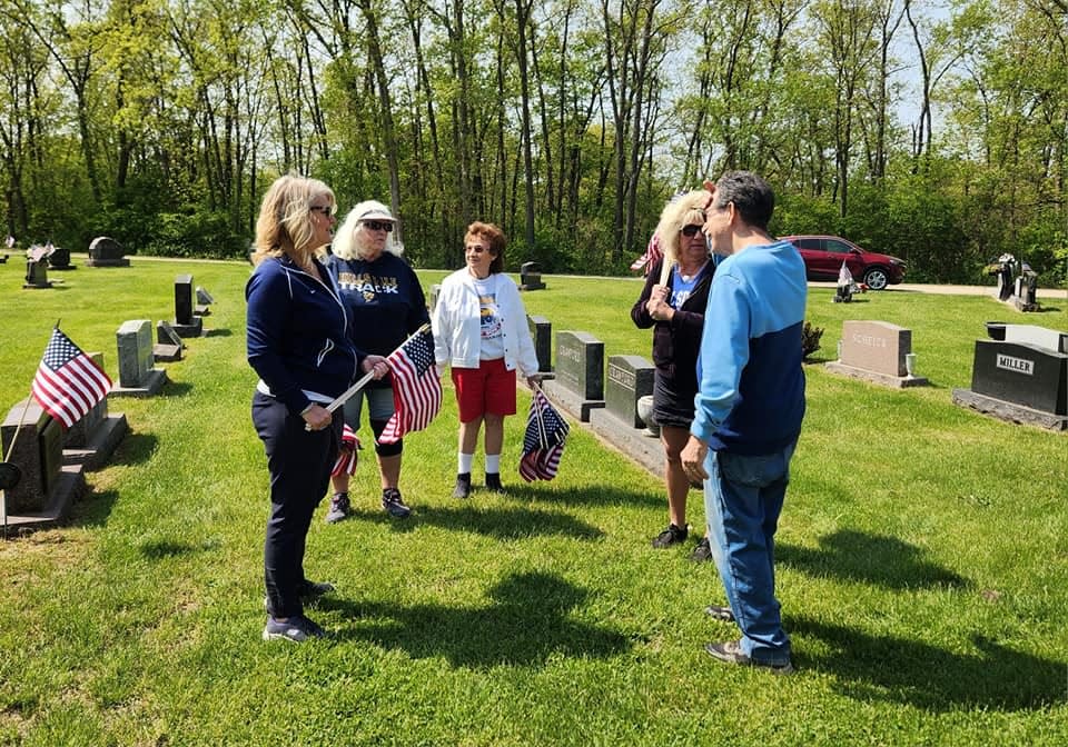 Members of the Hillsdale American Legion Auxiliary work to place flags at Lakeview Cemetery in Hillsdale this past week.