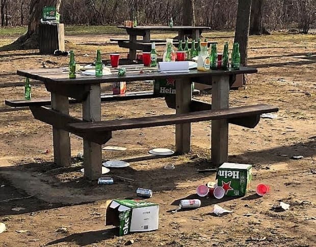 Empty bottles and litter left at Vincent Massey Park on the weekend. Ottawa Mayor Jim Watson is calling for an 8 p.m. park curfew in order to limit gatherings during the third wave of COVID-19. (Ian Black/CBC - image credit)