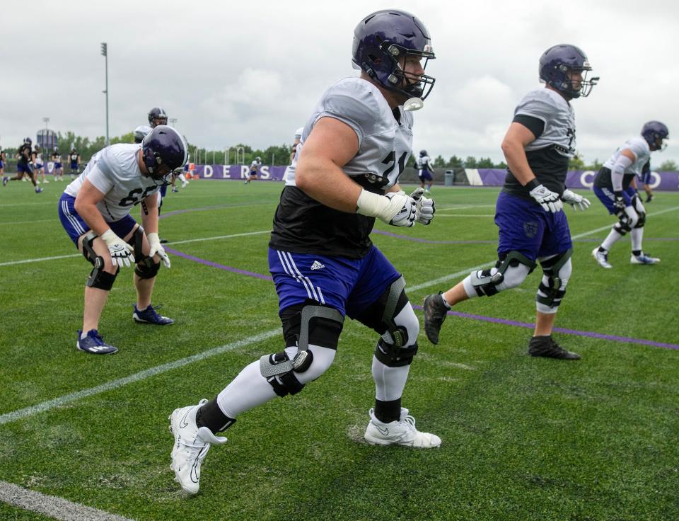 Holy Cross offensive lineman Luke Newman prepares to engage in a drill at practice Wednesday.