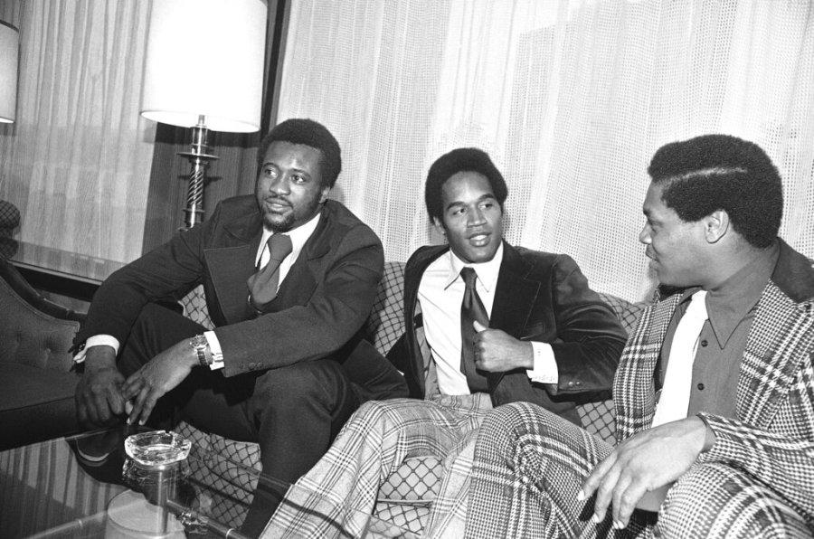 Larry Brown, left, Washington Redskins, O.J. Simpson of the Buffalo Bills and Carl Garrett, right, of the Chicago Bears, get together before New England Pro Football Awards dinner in Boston, May 20, 1973. They are among the candidates for the first annual Druker Award for the Outstanding Man in Professional Football. People at the dinner will vote and the award announced later at night. (AP Photo/Frank C. Curtin)