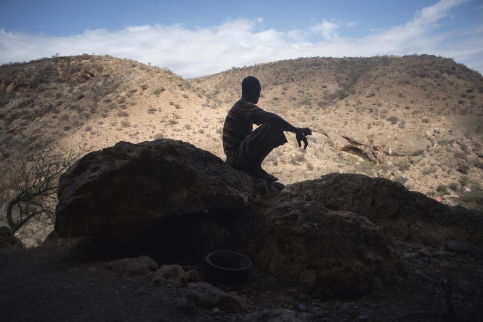 In this Wednesday, Aug. 3, 2016 photo, frankincense tapper Musse Ismail Hassan rests in a cave in a canyon near Gudmo, Somaliland, a breakaway region of Somalia. The last wild frankincense forests on Earth are under threat as prices rise with the global appetite for essential oils. Overharvesting has trees dying off faster than they can replenish, putting the ancient resin trade at risk. (AP Photo/Jason Patinkin)