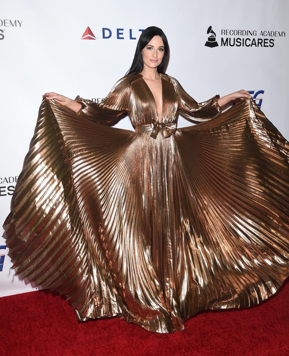 Kacey Musgraves at MusiCares wearing a J Mendel gold dress.