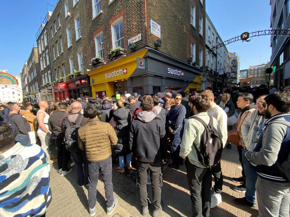 Customers congregate at the doors to the closed Swatch store on Carnaby Street, central London, after chaos broke out at the launch of the MoonSwatch, with late customers trying to barge their way into the store ahead of those who had waited in line overnight. The Omega x Swatch collaboration is a collection of solar system-inspired watches based on Omega's Moonwatch, the first wristwatch worn on the moon, but available for a fraction of the price. Picture date: Saturday March 26, 2022. (Photo by Yui Mok/PA Images via Getty Images)