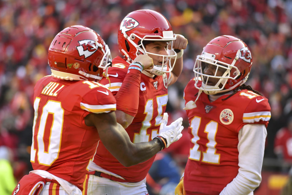 Kansas City Chiefs' Patrick Mahomes (15) celebrates with Tyreek Hill (10) and Demarcus Robinson after running for a touchdown during the first half of the NFL AFC Championship football game against the Tennessee Titans Sunday, Jan. 19, 2020, in Kansas City, MO. (AP Photo/Ed Zurga)