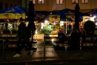 People enjoy drinks as the coronavirus disease (COVID-19) outbreak continues, in Berlin's Mitte district